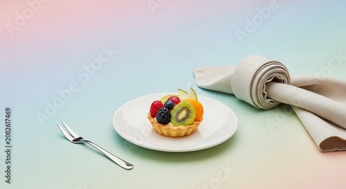 Delicious fruit tart on white plate.