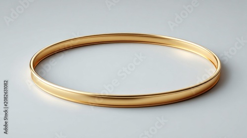 Simple gold bangle bracelet against a clean backdrop