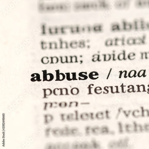 Dictionary page showing word abuse definition close up