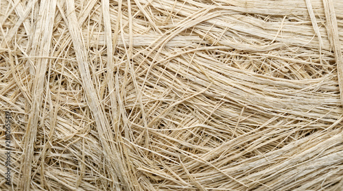 Extreme close-up of natural plant fiber texture, raw sustainable material background with copy space