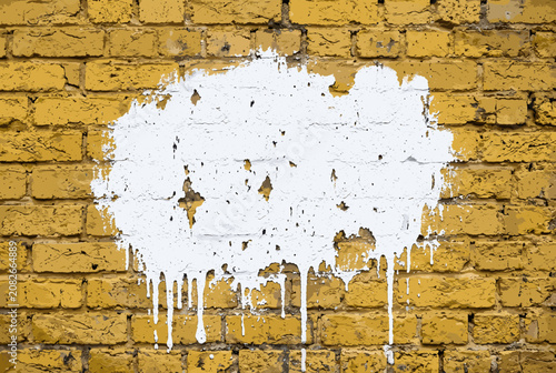 White Paint Drip Art on Yellow Brick Wall Background