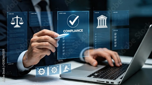 Corporate professional checking compliance regulations and legal rules on a futuristic holographic screen overlaying a laptop keyboard in an office.