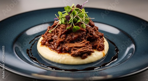Delicious Braised Beef Atop Creamy Polenta with Microgreens Garnish on Dark Plate