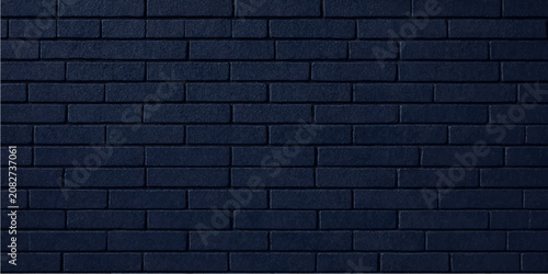Foto Dark blue brick wall texture background with staggered rectangular bricks and un