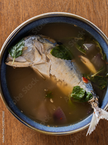 Cuadro en lienzo Delicious fish soup with herbs and spices in a rustic bowl