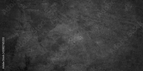 Fotografie A dark, textured, grunge background with subtle imperfections and a rough, concrete-like appearance, suitable for overlaying text or graphics