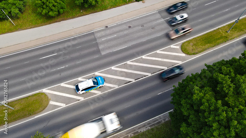 Fotografija Estonian traffic police car parked on a road median, monitoring speed limits whi