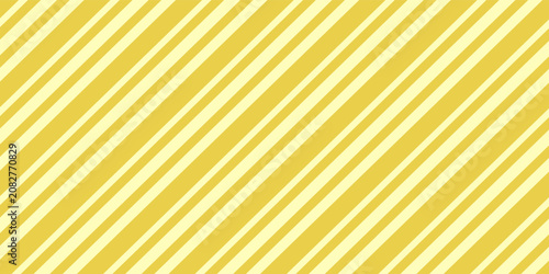 Trend color of the Year 2021 Illuminating yellow. Light golden background from wrapping paper for gift with striped pattern. Texture of holiday wallpaper backdrop.