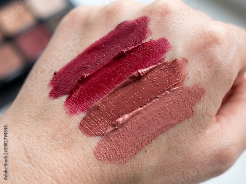 Various lipstick swatches on a person s hand for makeup testing