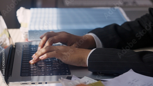 Photos Close-up of hands typing on a laptop