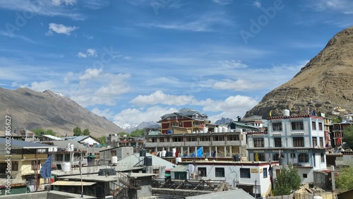 Kaza town spreads beneath rugged mountains, surrounded by hotels, homes, and dramatic Himalayan landscapes.