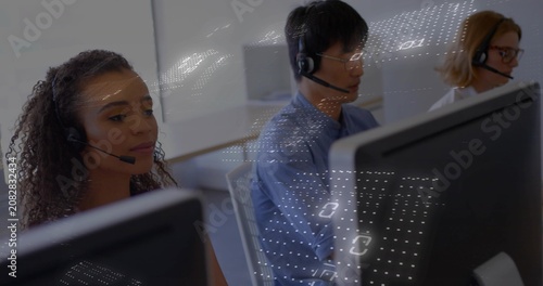 Call-center agents with mics typing while incoming calls driving binary grid sliding over monitors