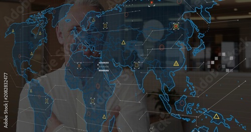 Senior male business exec uncrossing arms as holographic map fading in, reviewing Asia market data