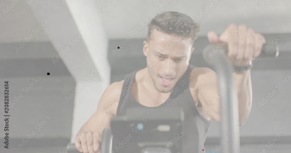 Fototapeta premium Man grasping handles and starting cardio in gym, fitness data tracking motion from console