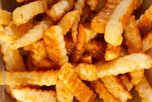 Schilderij op canvas A top down view of a pile of cajun crinkle cut fries, as a background