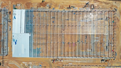 Canvastavla Industrial Construction Site: An aerial view captures a large-scale industrial construction project, showcasing the framework of a new building amidst ongoing development and infrastructure work