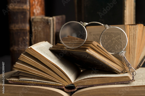Lorgnette on stack of antique books