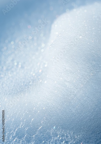 Fluffy white soap suds texture close-up abstract background. Light and airy foam washing cleanser detail, abstract, clean, hygiene