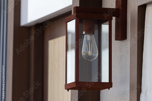 Close-up of a traditional lantern fixture on a modern home exterior wall
