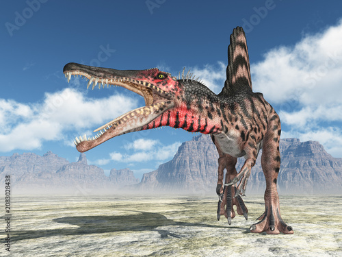 фотографія Dinosaurier Spinosaurus in einer kargen Berglandschaft