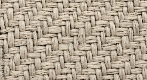 Closeup of woven fabric texture showcasing intricate pattern and neutral tone