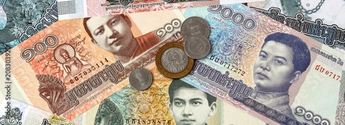 Obraz na plátně Cambodian riel money banknotes and coins on table