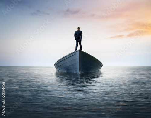 Businessman Standing on a Boat Reflecting Over Calm Waters at Sunset