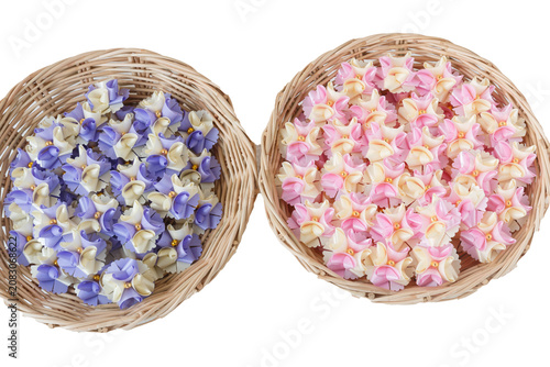 Handmade craft Thai festival decoration,Coins wrapped in floral ribbons on a basket against a white background.