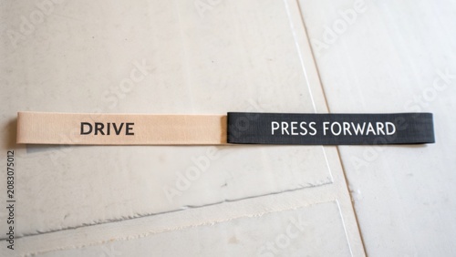 Motivational fabric bands with inspiring messages DRIVE and PRESS FORWARD on a textured background, ideal for encouragement
