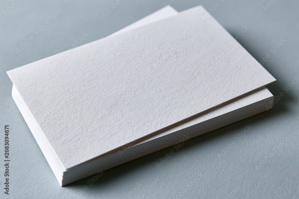 Fototapeta premium The Blank Business Cards Stack on a Soft Gray Background for Branding Mockup