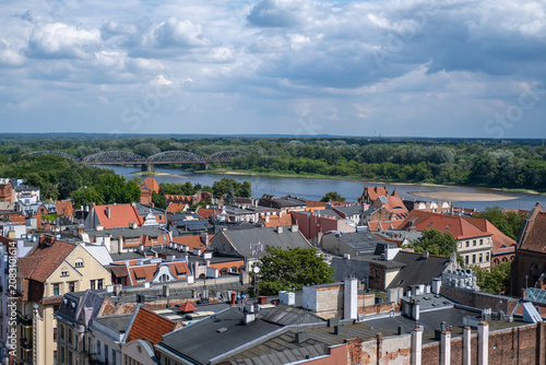 фотографія Scenic view over historic old town buildings in Torun towards the Jozef Pilsudski steel truss bridge crossing the Vistula River