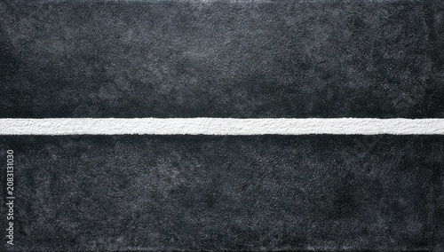 A stark white line bisects a textured, dark, gritty surface