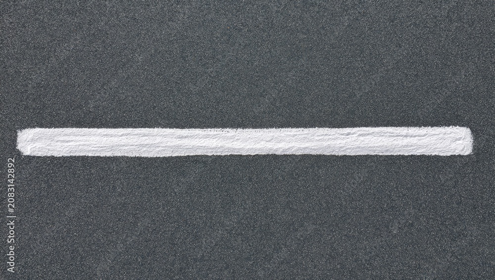 Fototapeta premium A stark white line bisects a textured dark gray background
