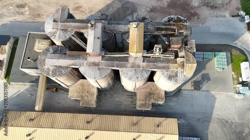 Aerial view of industrial silos and storage facility showcasing the continuous layout of cylindrical structures and surrounding elements in a commercial setting
