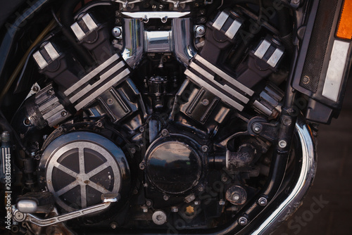 Fotografie Close-up of a powerful classic motorcycle engine with black metal and chrome par