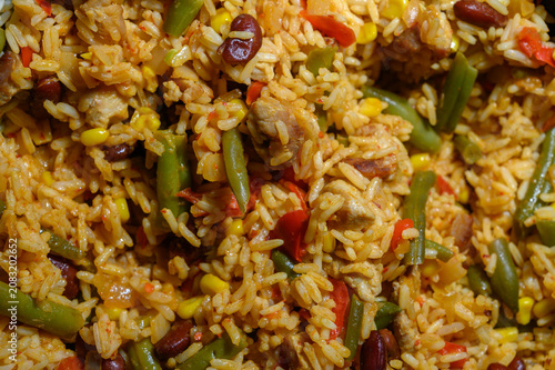Photography Savory rice dish featuring colorful vegetables and tender chicken cooked in vibr