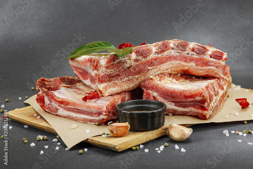 Raw marinated pork ribs prepared for BBQ picnic with spices, garlic and bay leaves
