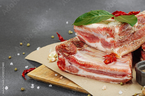 Raw marinated pork ribs prepared for BBQ picnic with spices, garlic and bay leaves