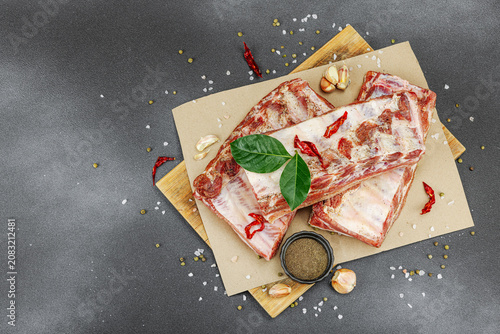 Raw marinated pork ribs prepared for BBQ picnic with spices, garlic and bay leaves