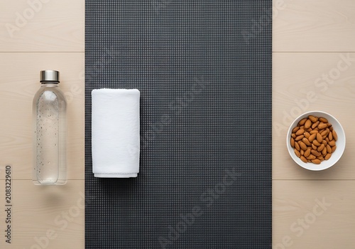 Healthy Lifestyle Flat Lay Yoga Mat, Water Bottle, Towel, and Almonds for Fitness  Wellness