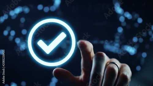 Person touching glowing blue checkmark icon on virtual interface against dark background