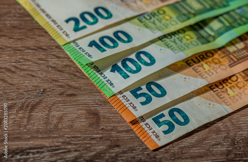 Konstfotografi Detailed arrangement of euro banknotes on a wooden surface showcasing various de