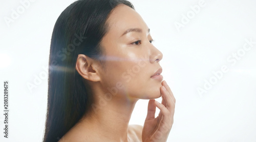 Side profile beauty portrait of an asian woman with glowing skin