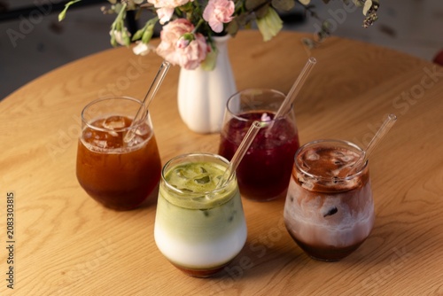 фотографія Four specialty iced beverages on wooden table