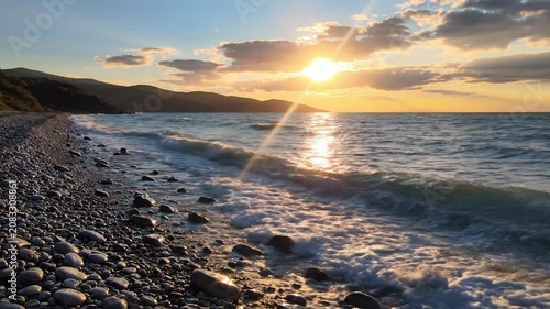 Golden sunset over a rocky beach with crashing ocean waves