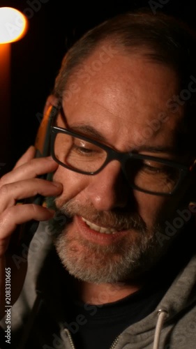 Smart handsome adult man use his smart phone outside in the city. Using smartphone technology makes him smiling happy wearing urban outfit. vertical video