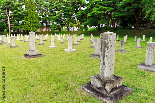 Rows of historic stone gravestones at Kobata Army Cemetery in Aomori