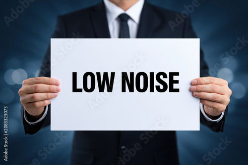 Businessman holding sign with low noise text in dark suit against blurred blue background