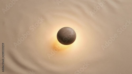 Floating stone sphere with warm glow on rippled tan surface