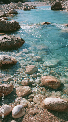 Clear waters lap against smooth rocks in a peaceful coastal scene